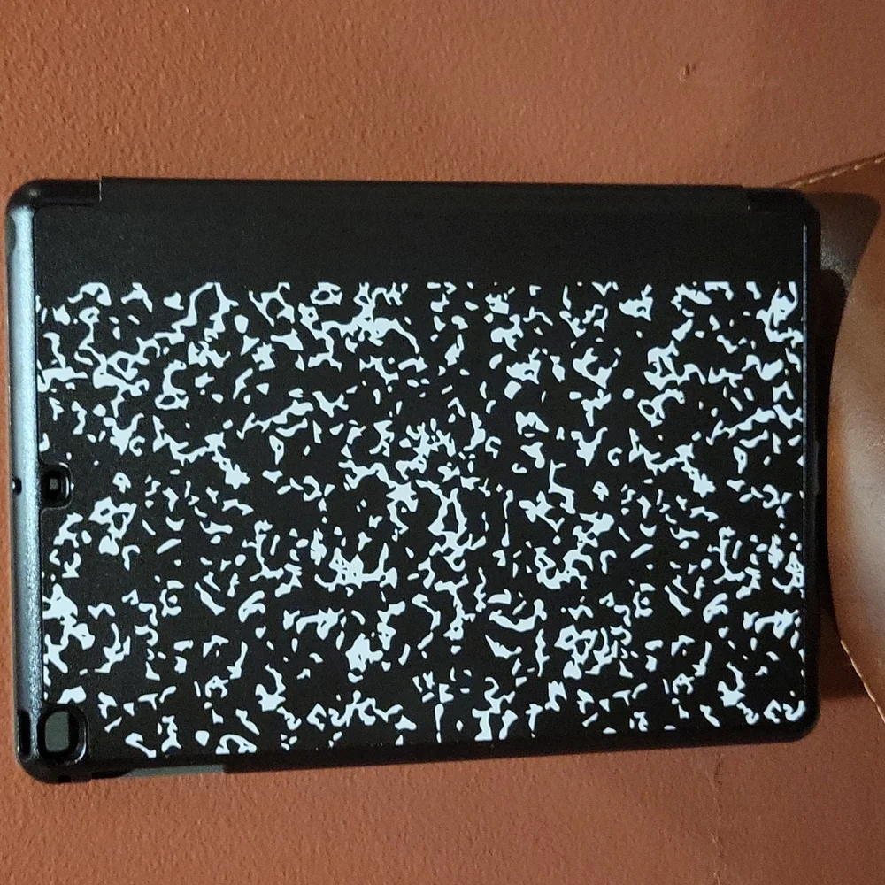 IPad min cover that looks like a school composition book and it black and white